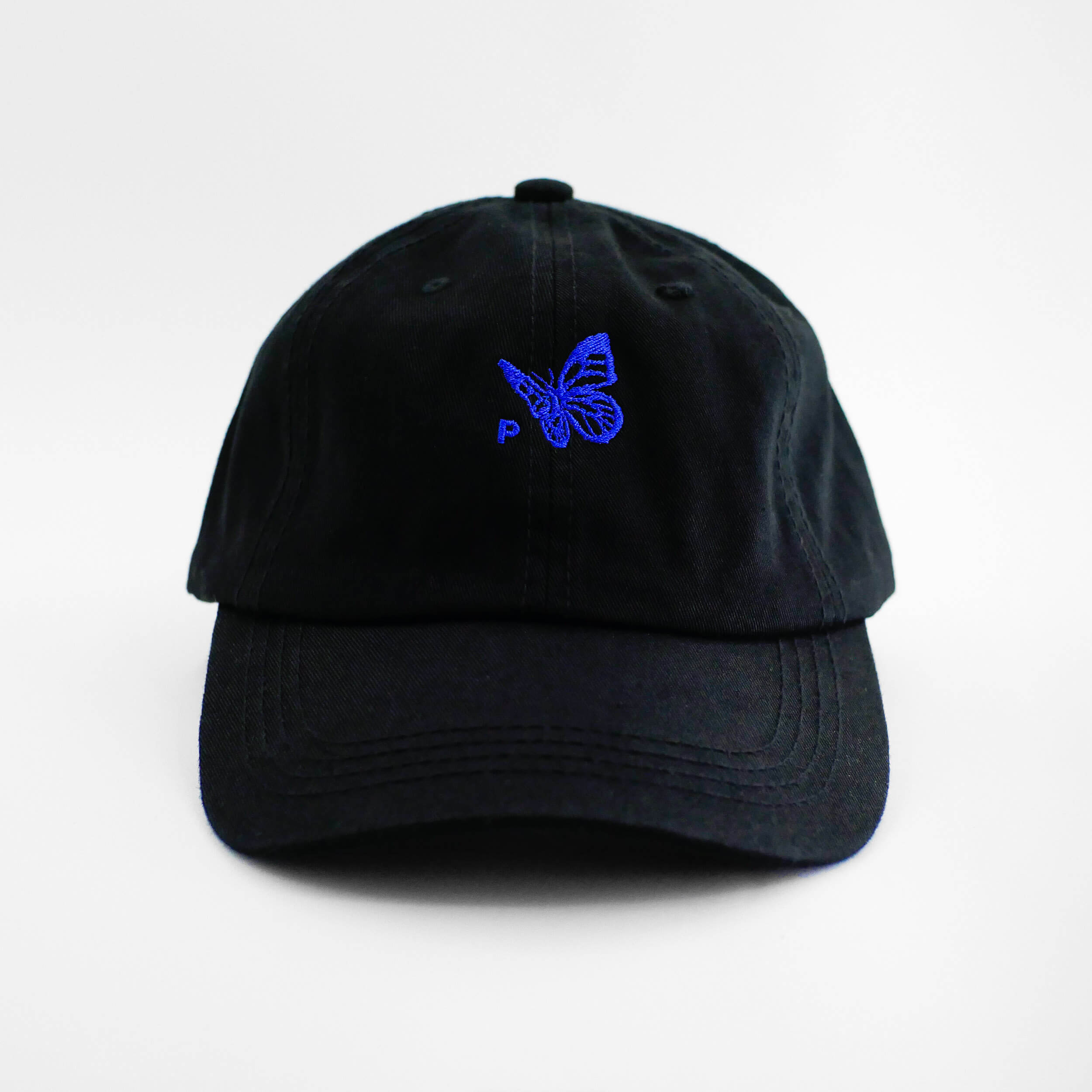 Front view of the embroidered Buttterfly Logo black dad hat from PHOSIS Clothing