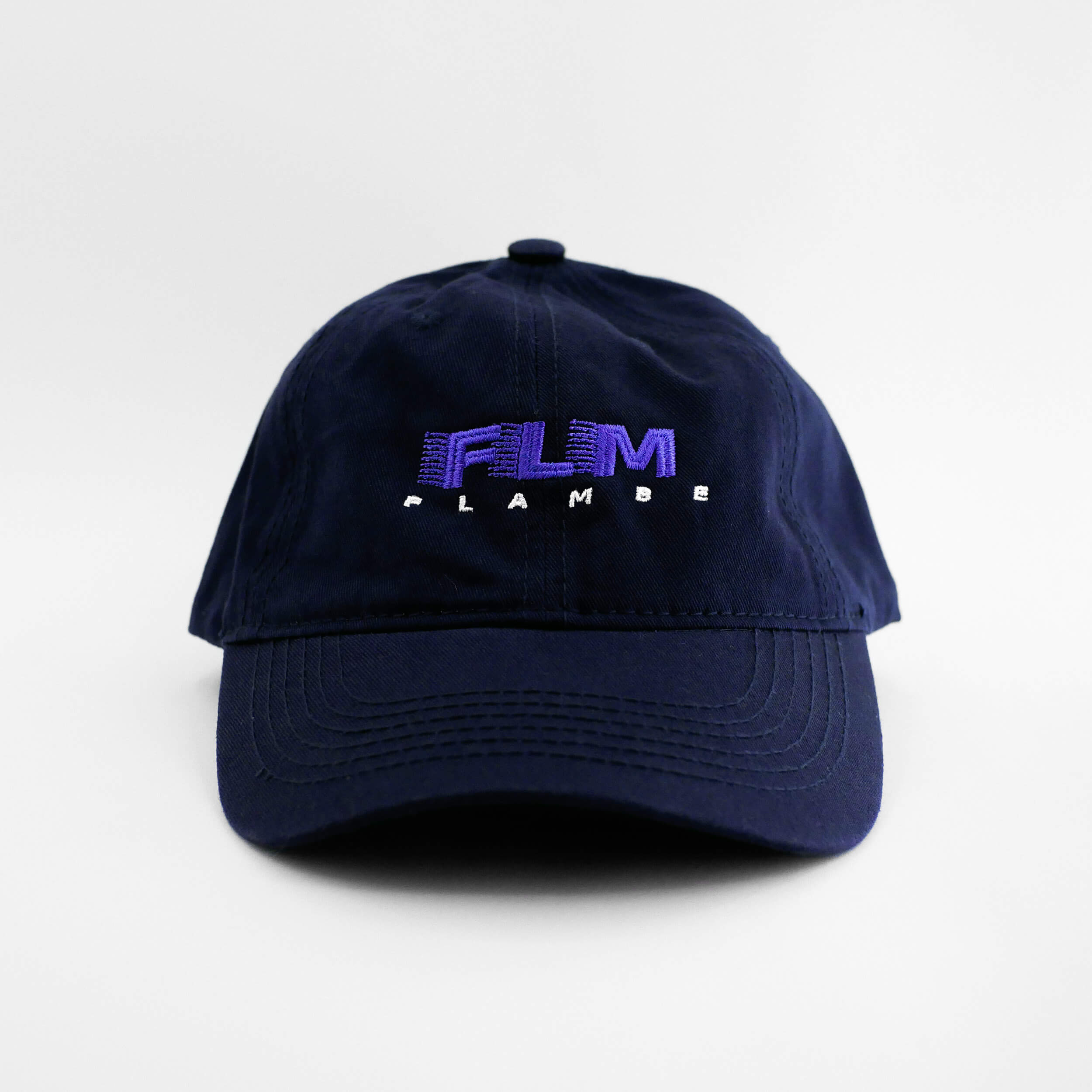 Front view of the embroidered 'FLAMBE' navy blue hat from PHOSIS Clothing