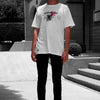 Front view of model wearing FLEUR DE PEAU TEE white t-shirt from PHOSIS Clothing