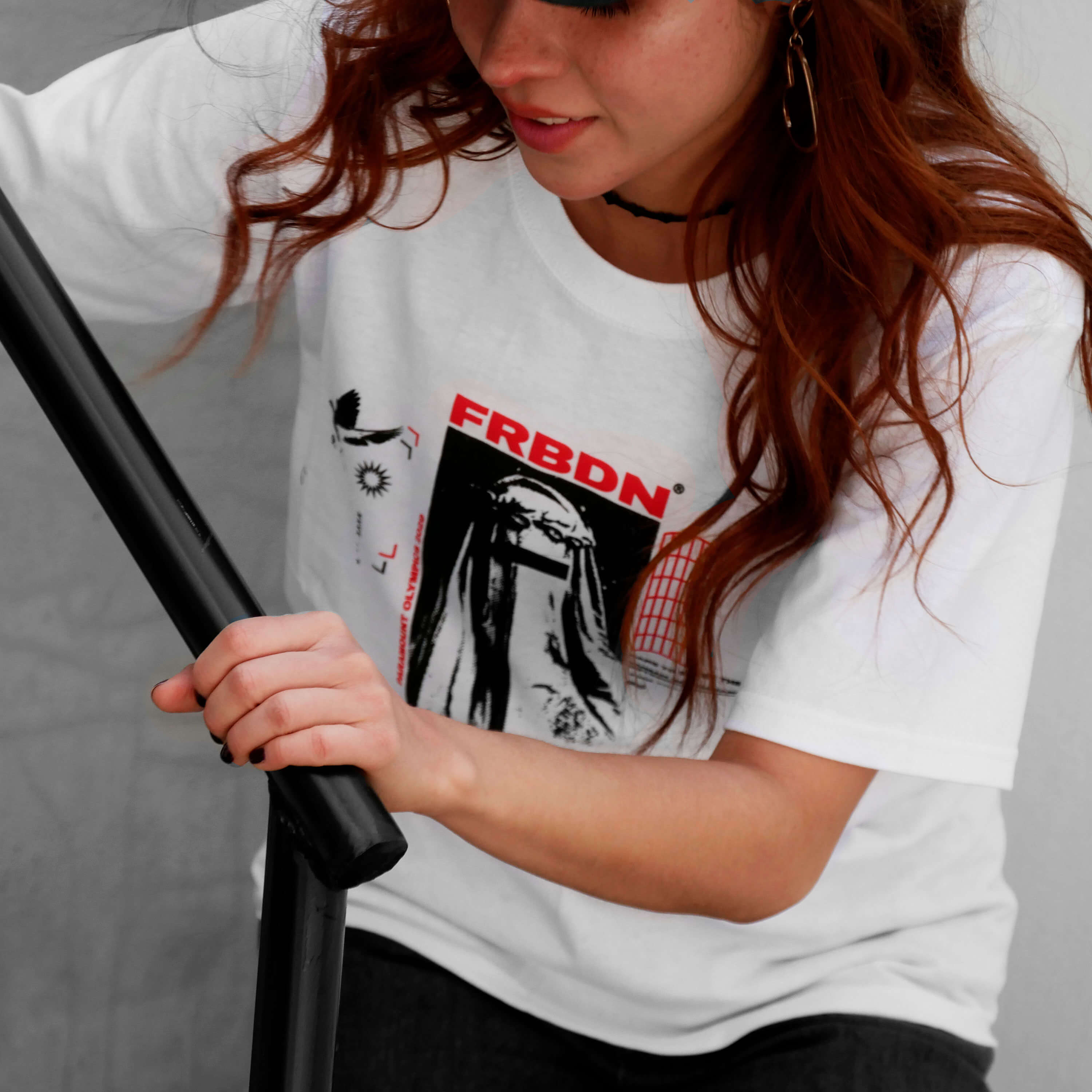 Angle view of model wearing FORBIDDEN white t-shirt from PHOSIS Clothing