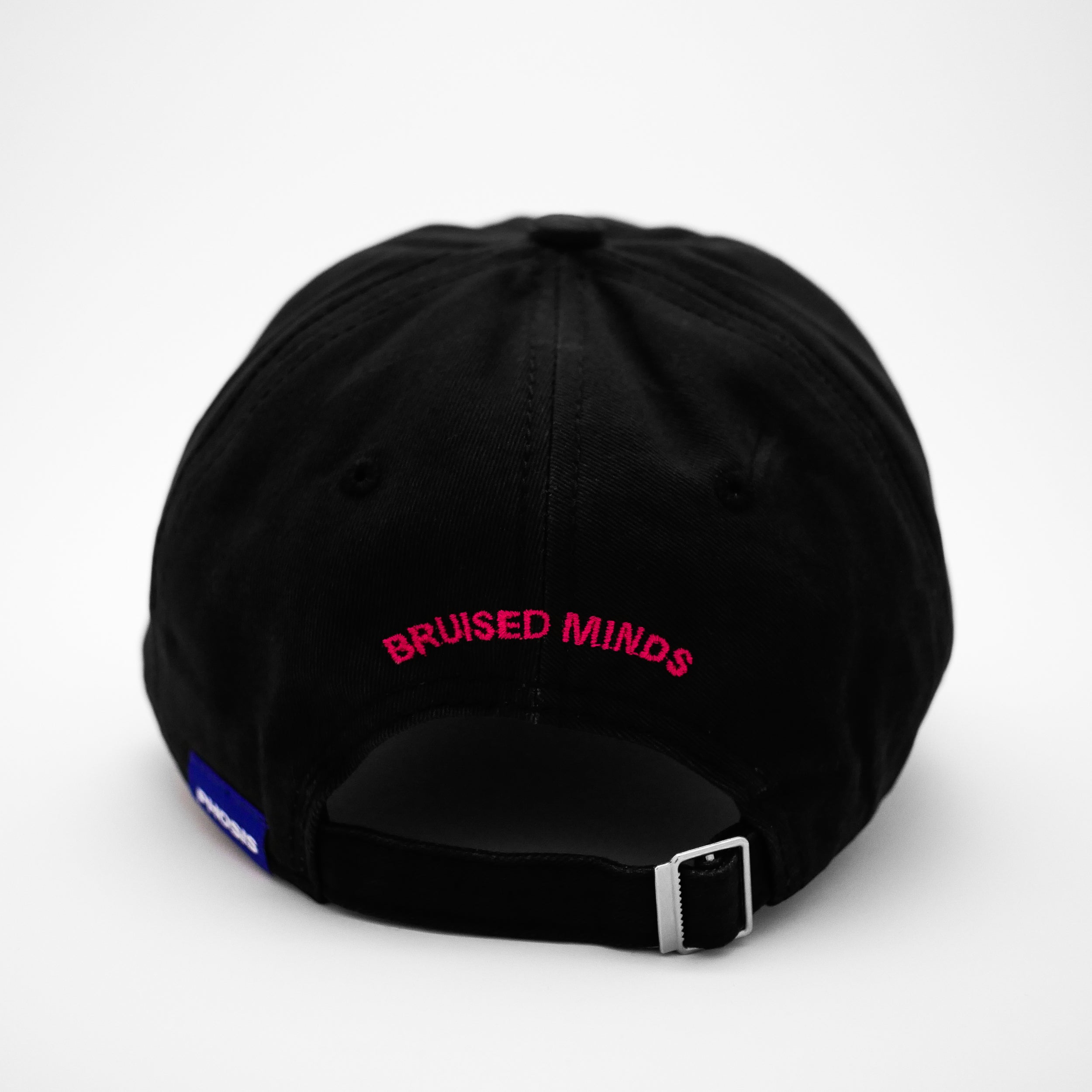 Back view of the embroidered BRUISED black dad hat from PHOSIS® Clothing