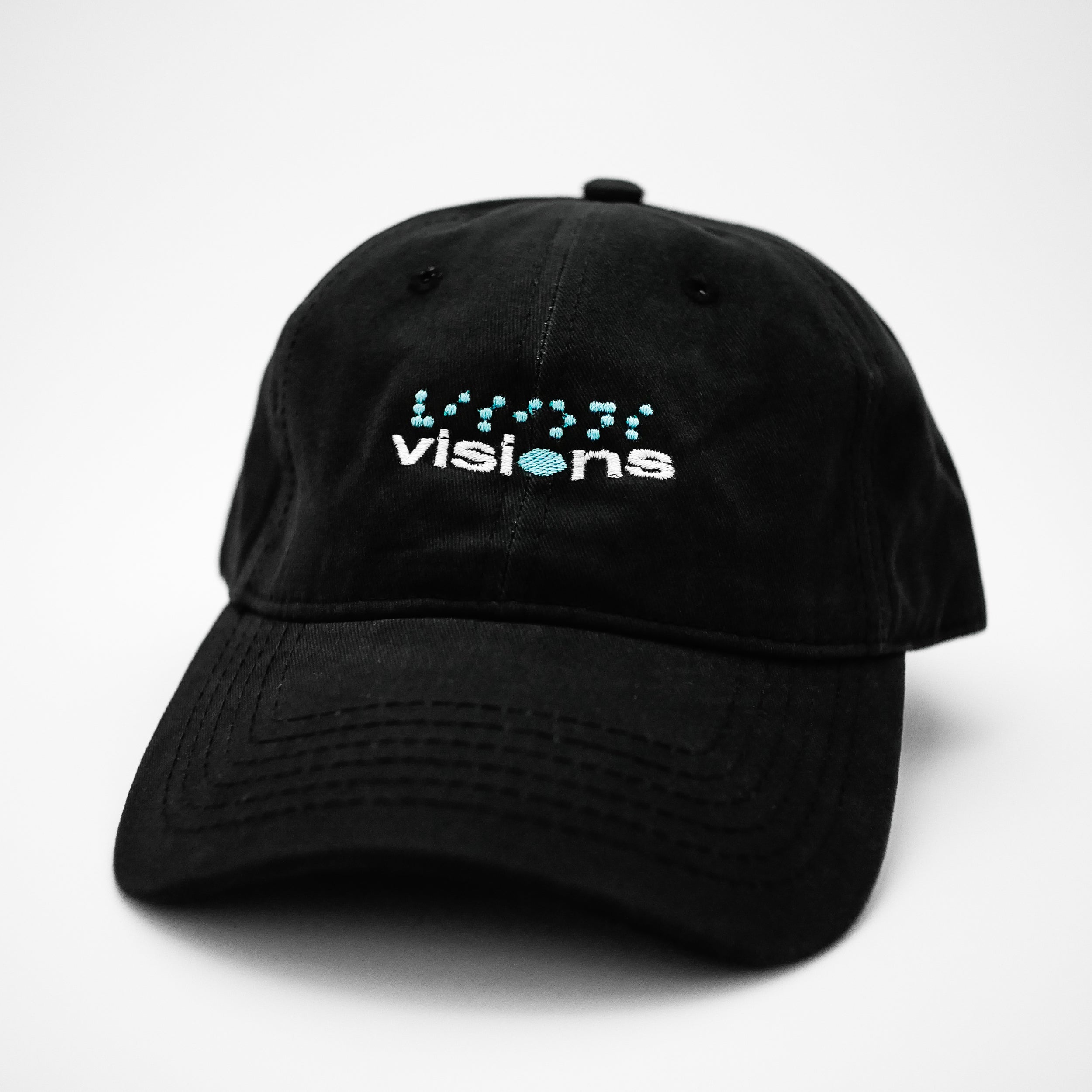 Angle view of the embroidered VISIONS black dad hat from PHOSIS® Clothing